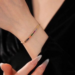 Macro detail of adjustable rainbow zircon bracelet with colorful gradient square gemstones
