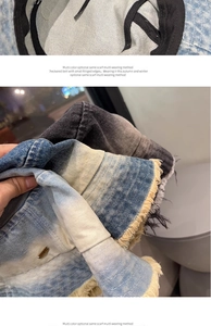 Detail of frayed edges and metal brand logo on gradient wash denim bucket hat