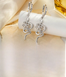 Detail of silver snowflake snake earrings with zircons and 9mm inner diameter ring