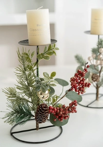 Detailed Christmas candle holder with pine needles, red berries, and small golden bells