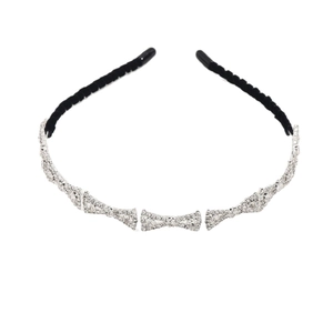 Elegant velvet-wrapped headband with silver rhinestone bow patterns on white background