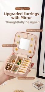 Pink portable jewelry box with mirror and twill texture, showing multi-slot storage
