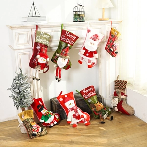 Festive Christmas stockings with 3D Santa and Reindeer figures hanging by the fireplace