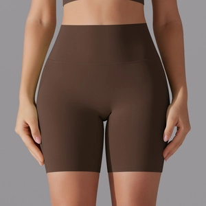 Detailed front view of high-waisted seamless dark brown yoga shorts on model in studio