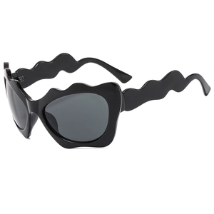 Y2K wavy frame cat eye sunglasses with grey lenses and black frames in 45-degree view