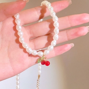 Sweet vintage pearl necklace with red cherry pendant and adjustable gold chain link