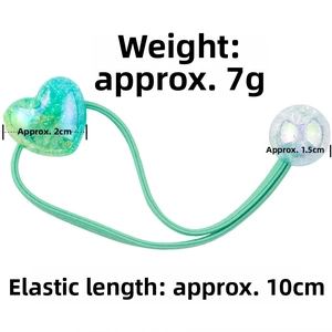 Detail showing green heart hair tie dimensions with 2cm heart and 10cm elastic band