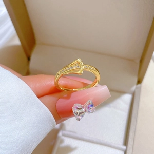 Adjustable gold ginkgo ring with sparkling zircons displayed on a jewelry box