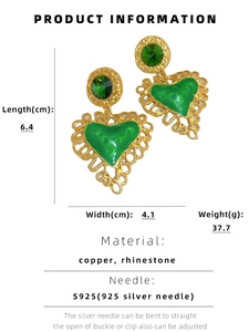 Macro detail of vintage heart earrings with green enamel, rhinestones and S925 silver pins