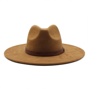 Detailed view of brown wide brim fedora with leather decorative band and metal buckle