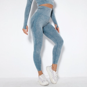 Detail of high-waisted seamless knit leggings in washed blue showing side ribbed texture