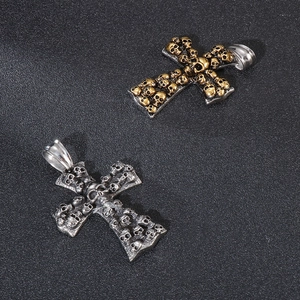 Macro detail of gothic skull cross pendants in silver and two-tone gold finishes