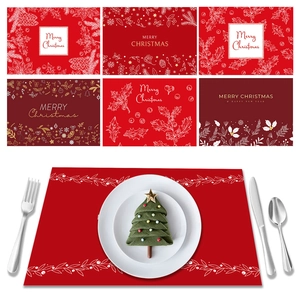 Christmas place mats set featuring red festive patterns with snowflakes and pine cones