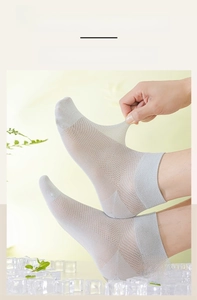 Detailed shot of elastic cuffs on breathable grey mesh socks for men with high stretch