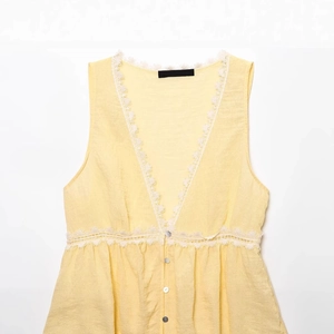 Pale yellow sleeveless V-neck top with white lace trim and front buttons flat lay