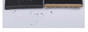 Detail view of premium full-grain black leather belt showing solid dye through process