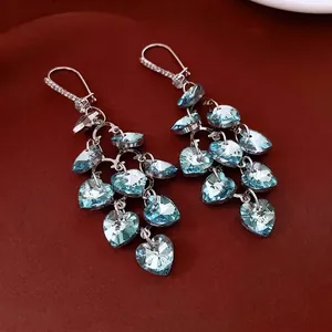 Sparkling heart tassel earrings with light blue crystals and silver diamond-set hooks