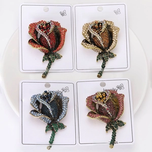 Detailed comparison of elegant rose brooches in red, gold, blue, and pink with rhinestones