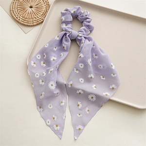 Detail of light purple chiffon scrunchie with daisy print and long elegant ribbon