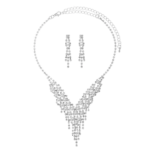 Elegant silver bridal jewelry set with sparkling rhinestones and white pearls on white background