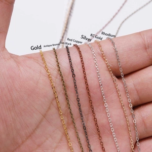 Assorted electroplated DIY metal chains in seven metallic finishes displayed on hand