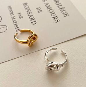 Detailed view of S925 sterling silver knot rings in gold and silver finishes