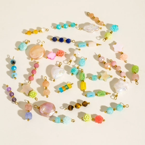 Colorful DIY jewelry charms including natural stones, baroque pearls and resin shapes