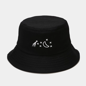 Detailed close-up of celestial moon and star embroidery on a black cotton bucket hat