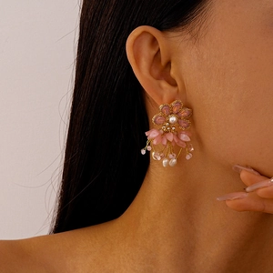 Detail of pink floral tassel earrings with freshwater pearls and golden fringes