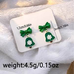 Macro shot of green Christmas snowflake earrings with size and weight annotations