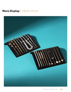Macro detail of black velvet curved jewelry display rack for necklaces and bracelets