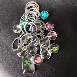 Handmade clear resin keychain collection with real pressed flowers and dandelion seeds