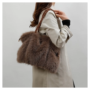 Detail of plush brown tote bag with premium woven leather strap and soft faux fur texture