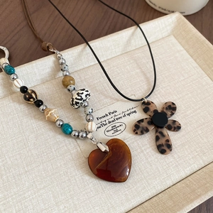 Handmade ceramic and stone beaded necklace with amber heart and leopard flower pendants