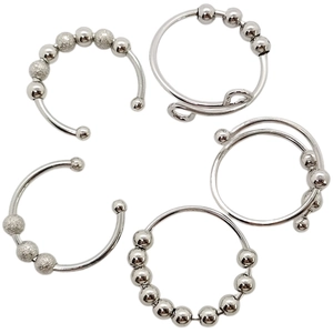 Detailed set of silver stainless steel anxiety rings with rotatable beads on white background