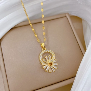 Detail of gold flower necklace with clear zircons and lip chain on silk fabric
