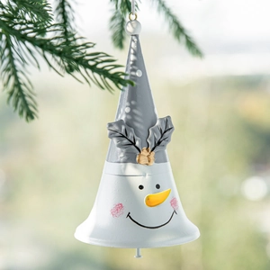 Snowman Christmas bell pendant with white polka dot hat hanging on pine branches