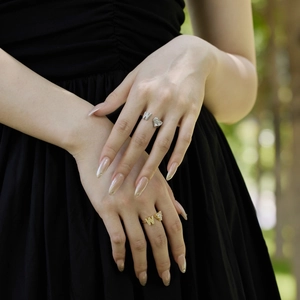 Close-up of sparkling S925 silver and gold butterfly rings with clear zircon stones