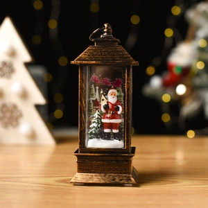 Macro detail of bronze Christmas lantern with Santa Claus figurine and warm LED lighting