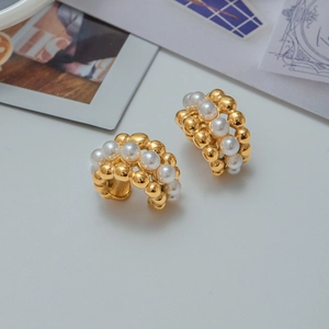 Elegant 18K gold plated stainless steel hoop earrings with white pearls on a minimalist background