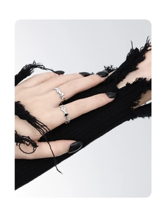 Detail of silver S925 rings with irregular geometric design on a punk-style hand