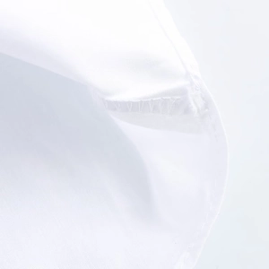 Detail shot of white woven cotton fabric showing premium stitching on collar and cuff