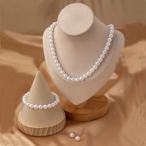 Elegant 8mm white pearl jewelry set including necklace, bracelet and earrings on gold silk