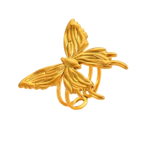 Macro detail of golden butterfly ring with layered textures and triple band design
