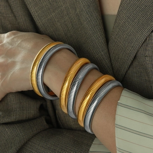 Vintage 10mm gold and silver Tubogas stretch bracelets in ribbed titanium steel style