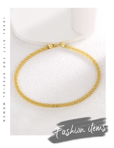 Detailed close-up of a gold-plated mesh chain necklace with a secure lobster clasp