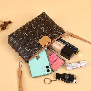 Classic monogram brown pouch with yellow pattern and zip closure showing daily storage capacity