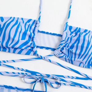 Detailed view of bikini top with navy and lilac zebra print and lace-up front detail