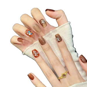 Brown cat eye press-on nails with sparkling rhinestones and glitter in a square-oval shape