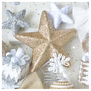 Close-up of glittery stars and gift box ornaments with luxurious sequins and ribbon details